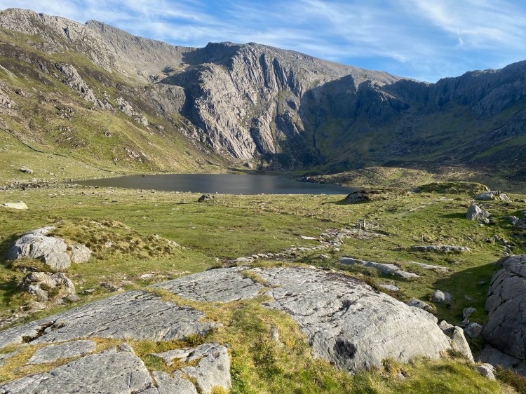 a sunny day at Llyn Idwal in the Ogwen Valley, Snowdonia, North Wales, overwritten with the National Navigation Award Scheme logo